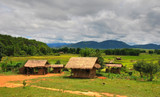 Traditional rural house surrounded by paddy fields and mountains. Northern Laos.