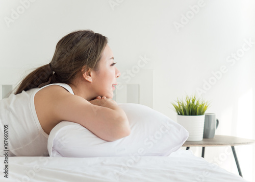 Young beautiful asian woman sleeping happy on white bed with happy feeling