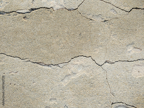 Cracked concrete wall covered with gray cement surface as background
