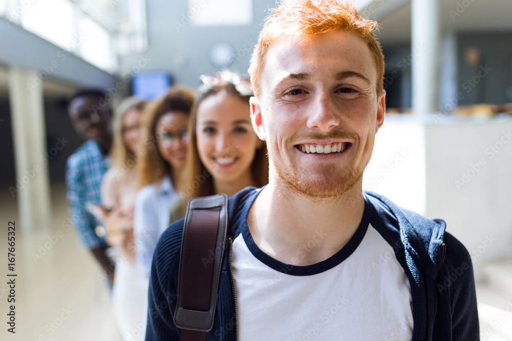Group of happy young students looking at camera in a university. Group of happy young students looking at camera in a university.