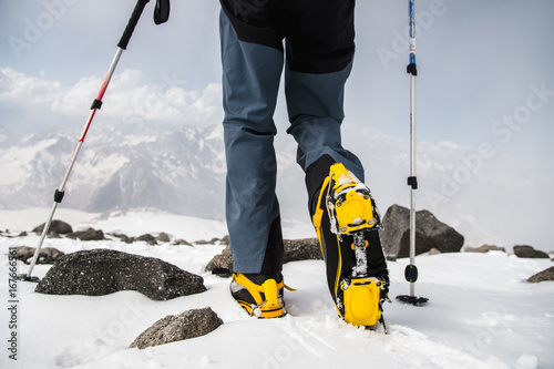 mans walking with crampons