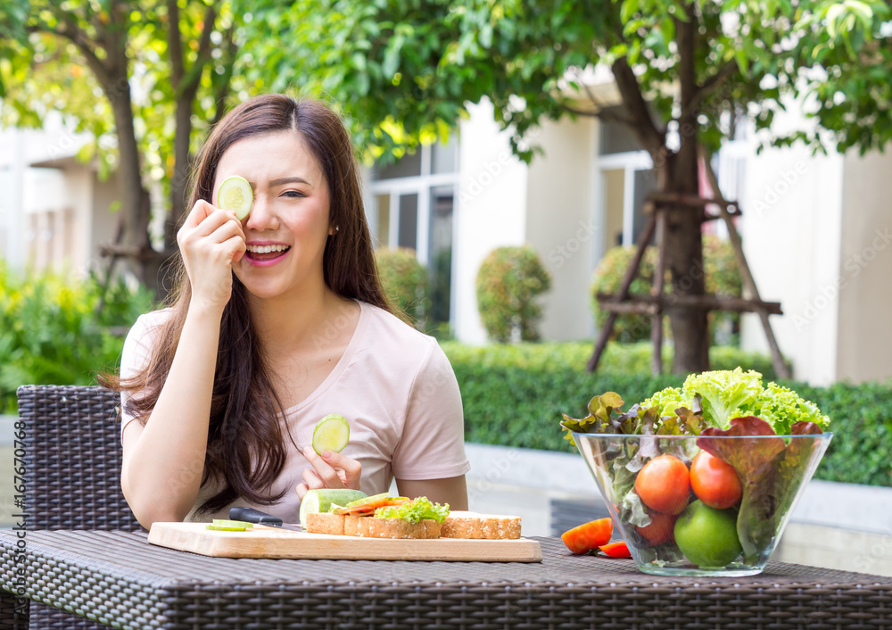 Young beautiful asian woman eating fresh clean food with vegetables and fruits for good healthy over green background, healthy food woman for diet Young beautiful asian woman eating fresh clean food with vegetables and fruits for good healthy over green background, healthy food woman for diet