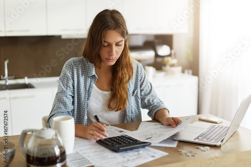 Принти на полотні Picture of young Caucasian woman wearing casual clothes at home, full of sad and