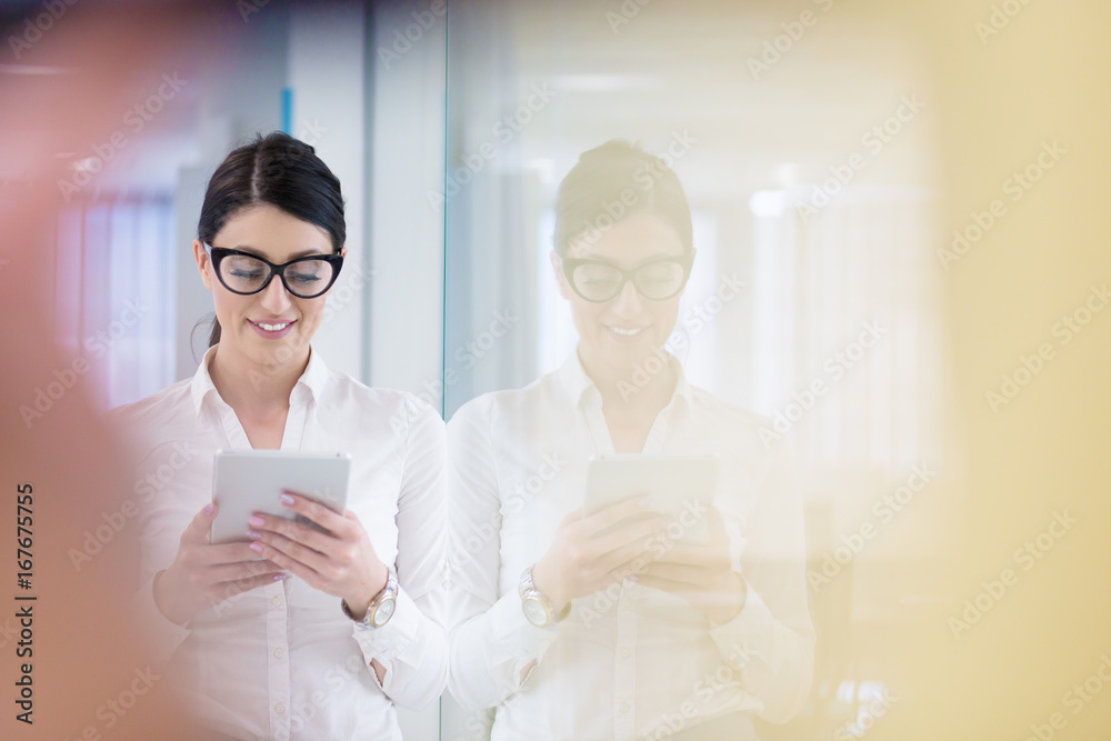 Business Woman Using Digital Tablet in front of startup Office