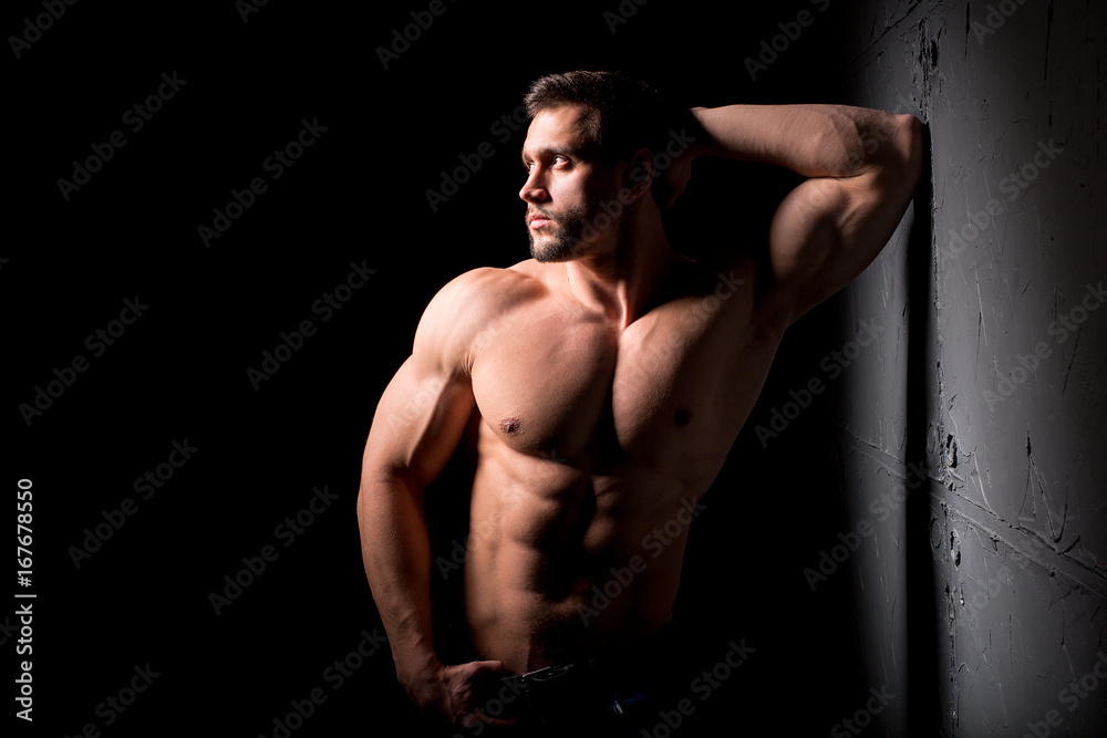 Fitness concept. Muscular and sexy torso of young man having perfect abs,  bicep and chest. Male hunk with athletic body. Photos | Adobe Stock