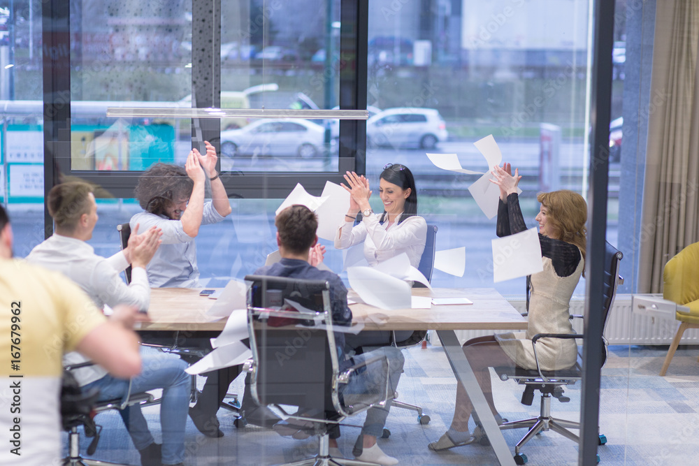 startup Group of young business people throwing documents