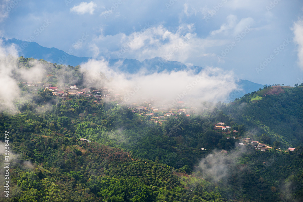 Mountain landscape of rural village house on top with cloud cover at Doi-Tung Chiangmai Thailand.