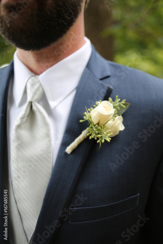 Groom in Blue Suit with a White Rose Boutonniere 