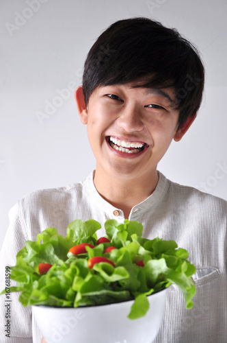Asian Woman with Happy Face Holding Salad Bowl
