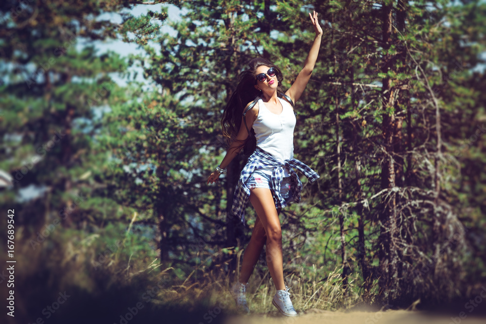 A beautiful young woman walking in the forest A beautiful young woman walking in the forest