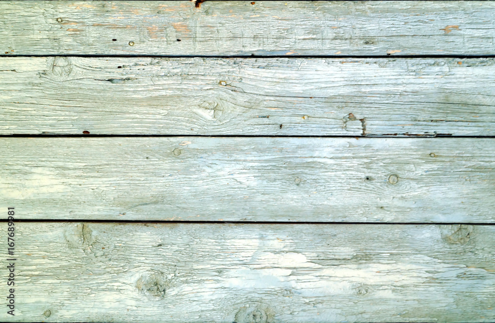 Wooden bars, painted in light blue color with cracked and peeling paint.