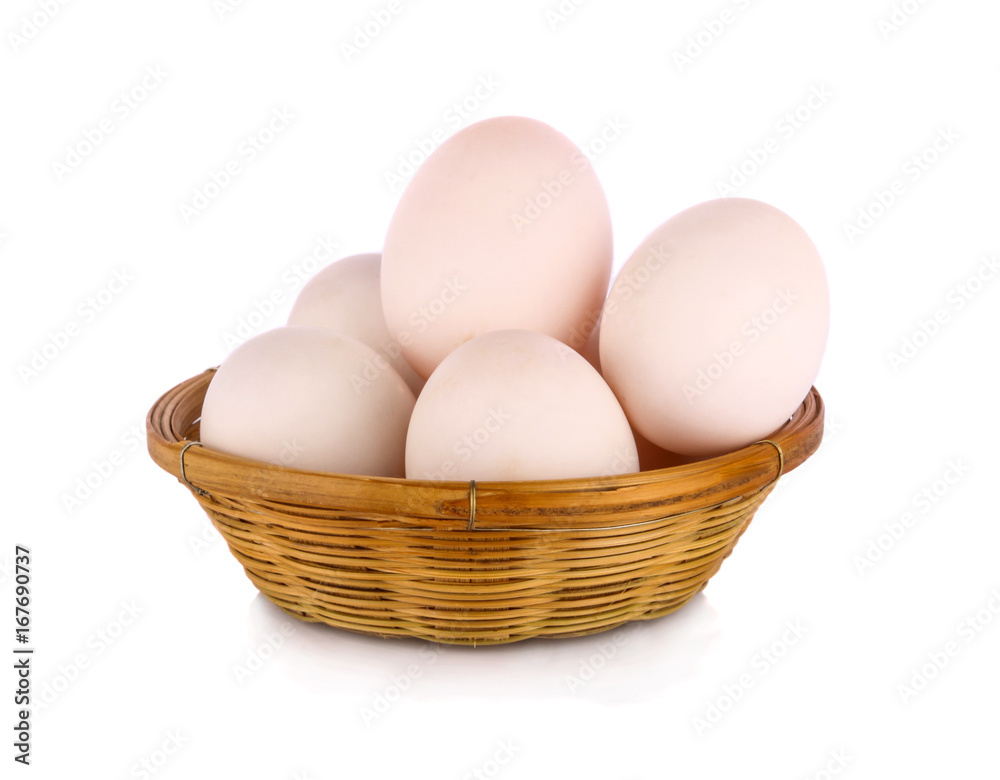 fresh raw duck eggs in bamboo basket and on white background fresh raw duck eggs in bamboo basket and on white background
