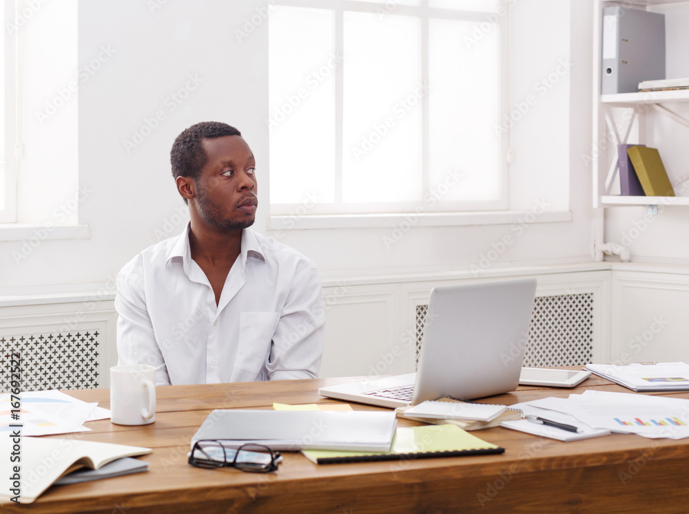 Thoughtful young black man enjoying his successful business Thoughtful young black man enjoying his successful business