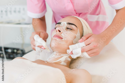 Facial mask removing at beauty salon photo