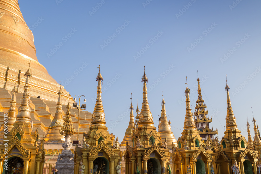 Many small pagodas in front of the Shwedagon Pagoda in Yangon, Myanmar on a sunny day.