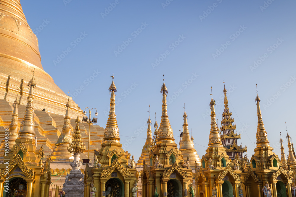 Naklejka premium Many small pagodas in front of the Shwedagon Pagoda in Yangon, Myanmar on a sunny day.