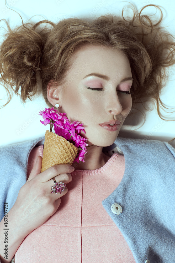 The beautiful girl with a small bouquet of violet flowers The beautiful girl with a small bouquet of violet flowers