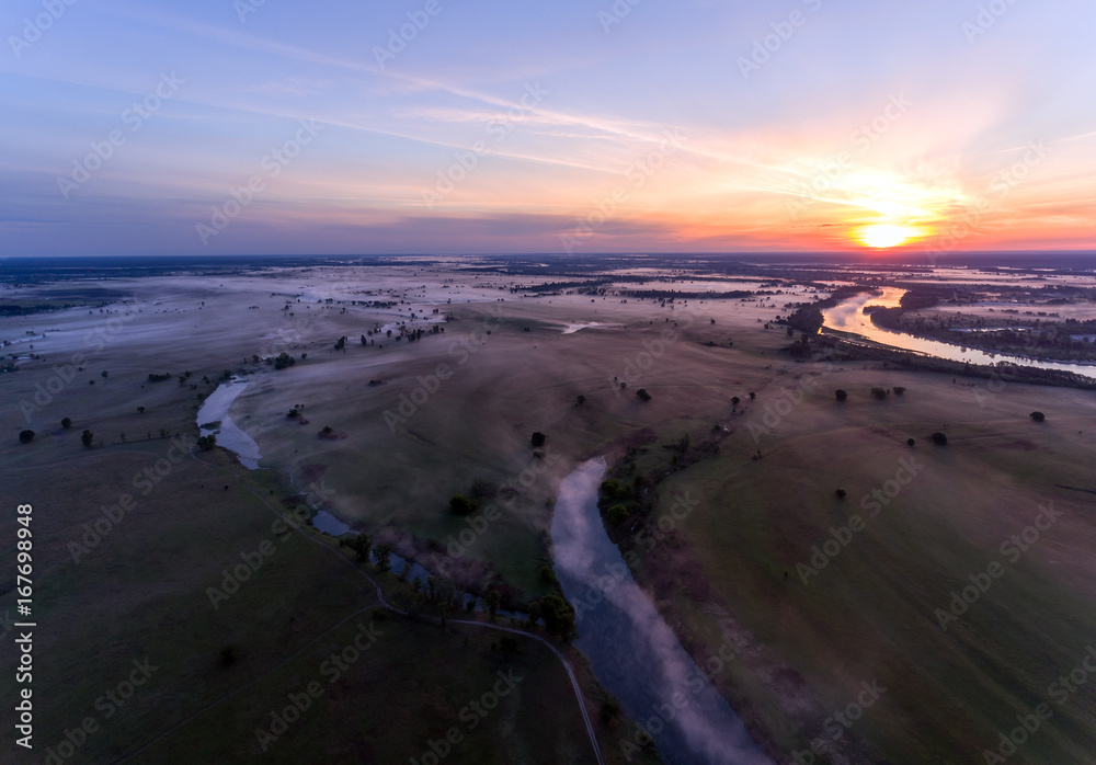 Aerial view of the dawn over the river in the fog