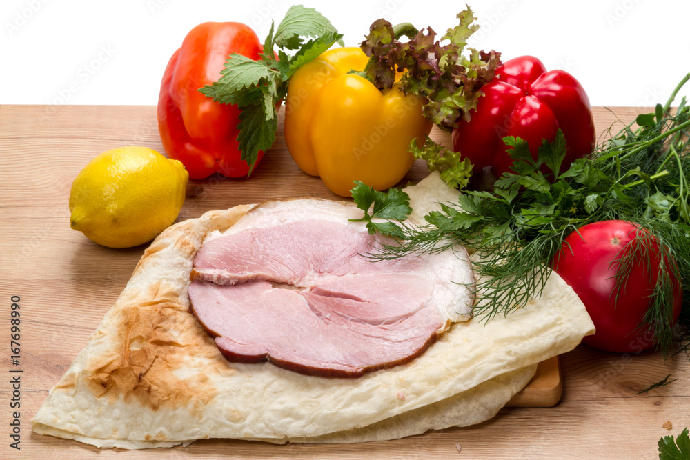 Pork loin on pita bread and vegetables Pork loin on pita bread and vegetables