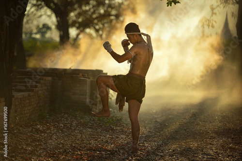 Muay thai, Thai Boxer training in sunset background,Thai boxer culture,Thailand photo