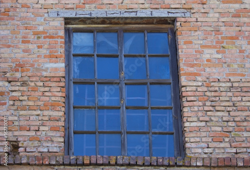 Old wooden window on brick wall.