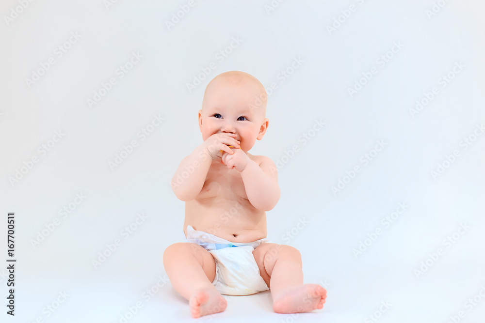 A happy baby is smiling on a light background. A cute boy. Emotions of a young child A happy baby is smiling on a light background. A cute boy. Emotions of a young child