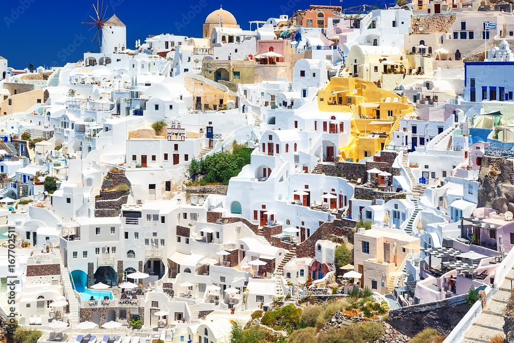 View of seaside on a summer day. Panorama of Oia village with colorful houses , view of Oia town, Santorini island, Greece