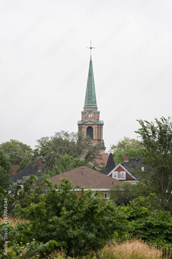 Church steeple overlooking sleepy town on a grey summer day