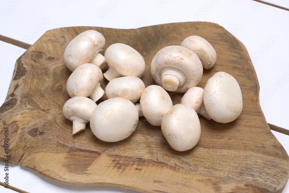 Fresh mushrooms on a white wooden table.