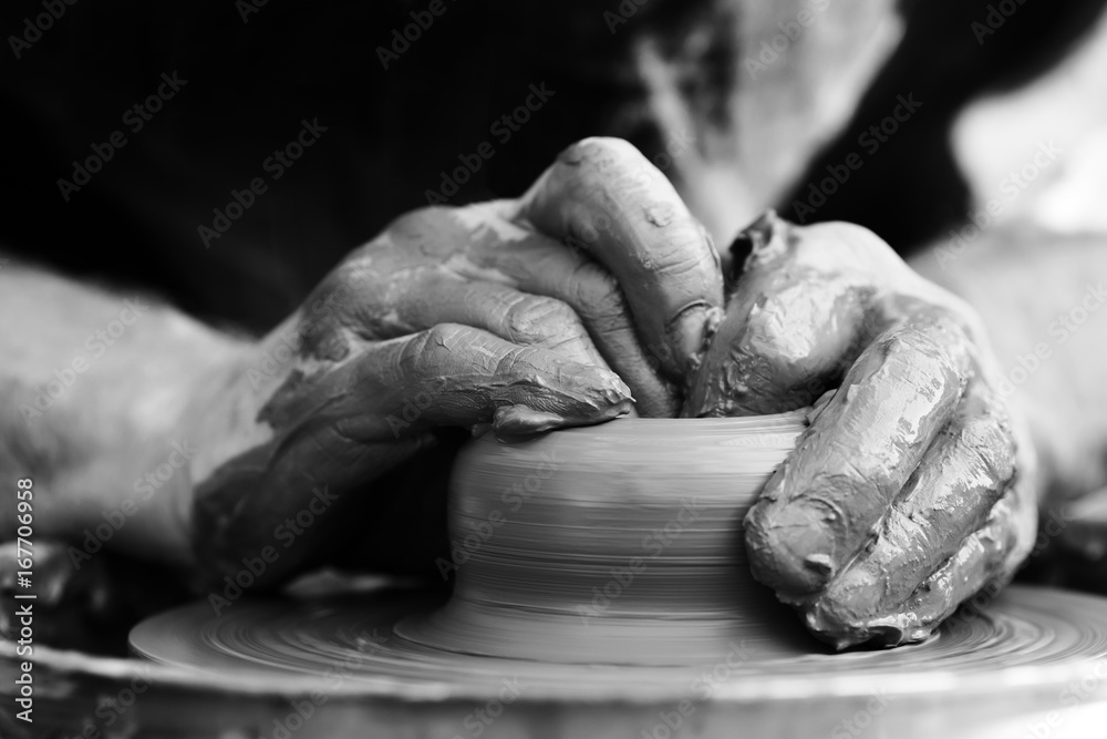 Potter making ceramic pot on the pottery wheel Potter making ceramic pot on the pottery wheel