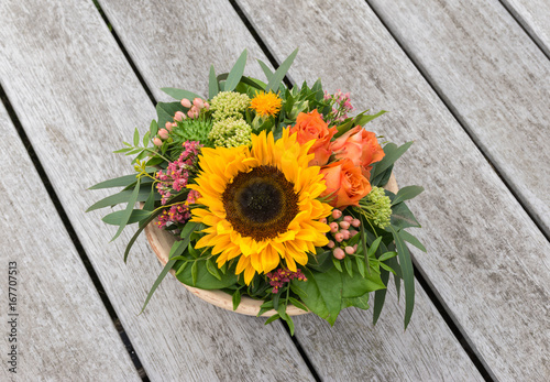 Flower arrangement on wooden table.