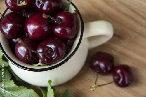 cherry in cup on wooden table