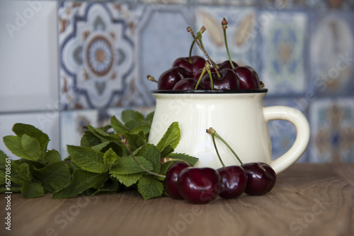 cherry in cup on wooden table