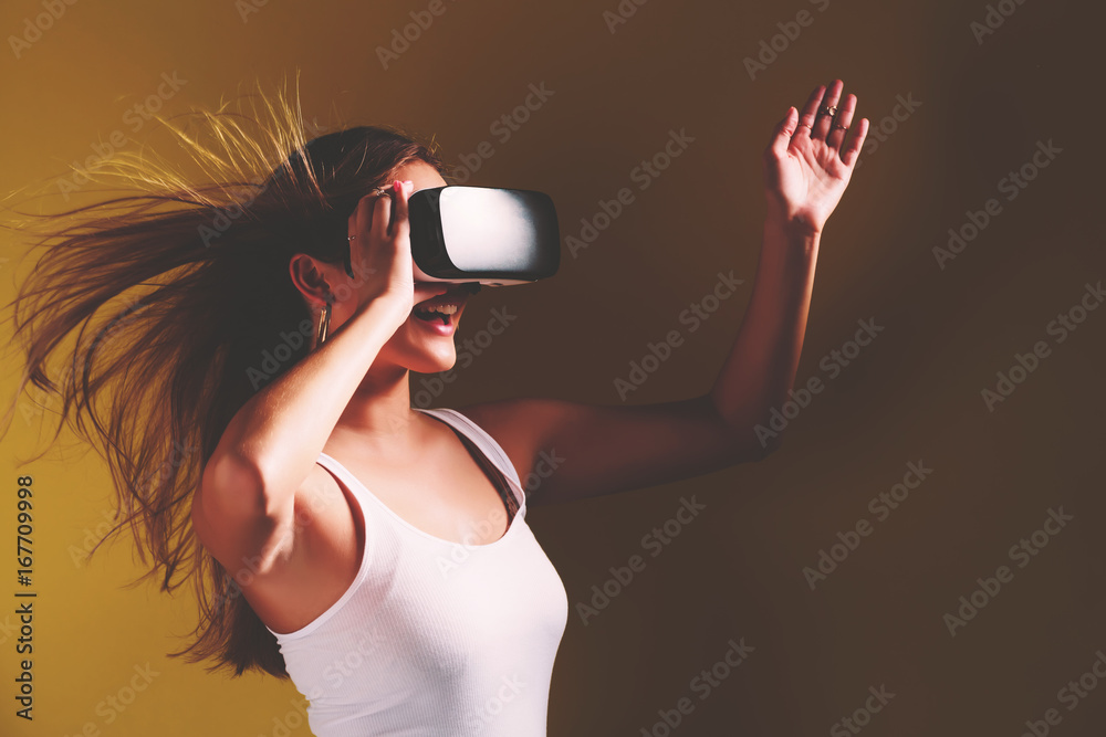 Obraz premium Happy young woman using a virtual reality headset