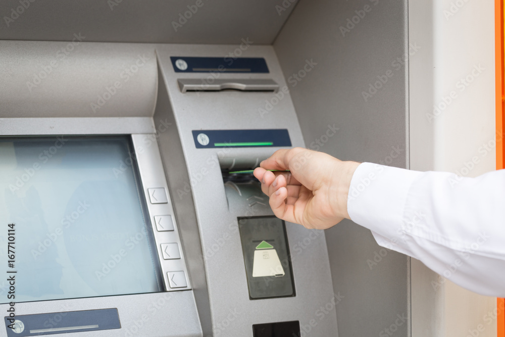 man hand insert credit card to atm man hand insert credit card to atm