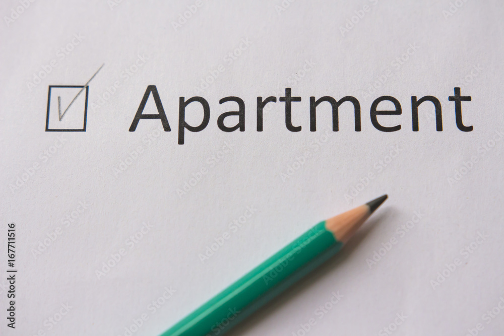 To buy an apartment. word APARTMENT is written on white paper with tick and gray pencil. To buy an apartment. word APARTMENT is written on white paper with tick and gray pencil.