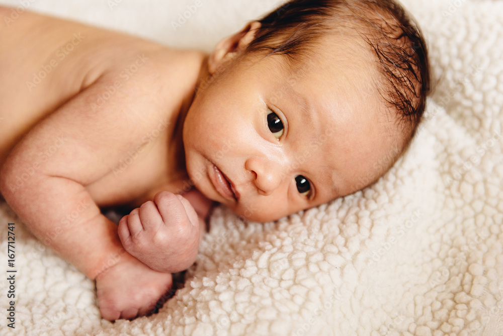 Newborn baby lying in a crib Newborn baby lying in a crib