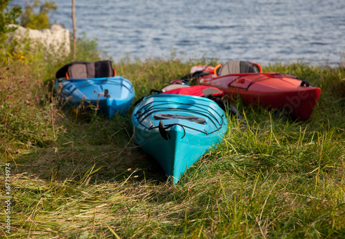 close up of three kayaks by lake photo