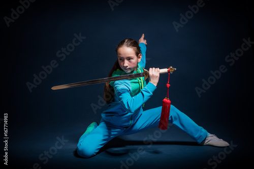 Girl in a blue wear engaged wushu photo