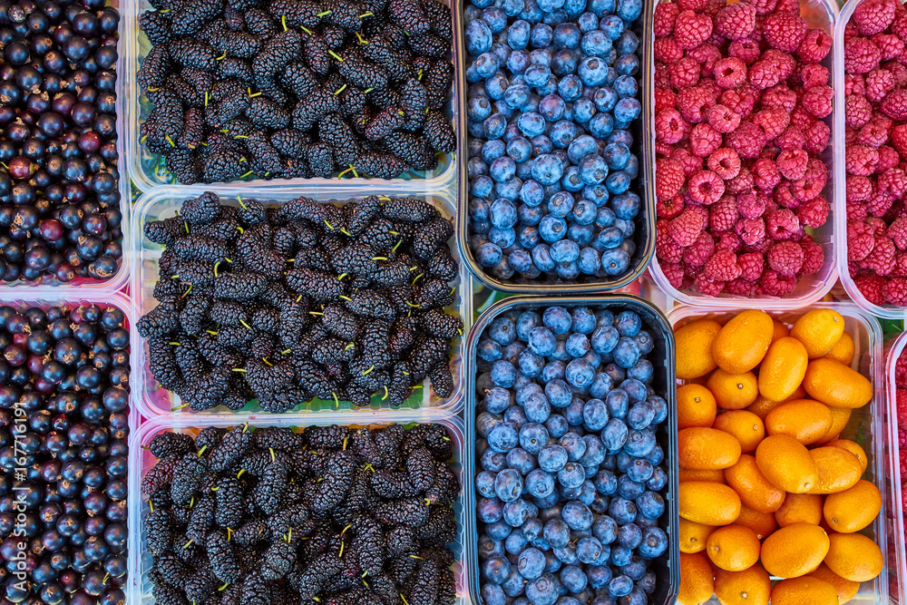 Baskets of berries in a market. mixed berries. bio colorful berries Baskets of berries in a market. mixed berries. bio colorful berries
