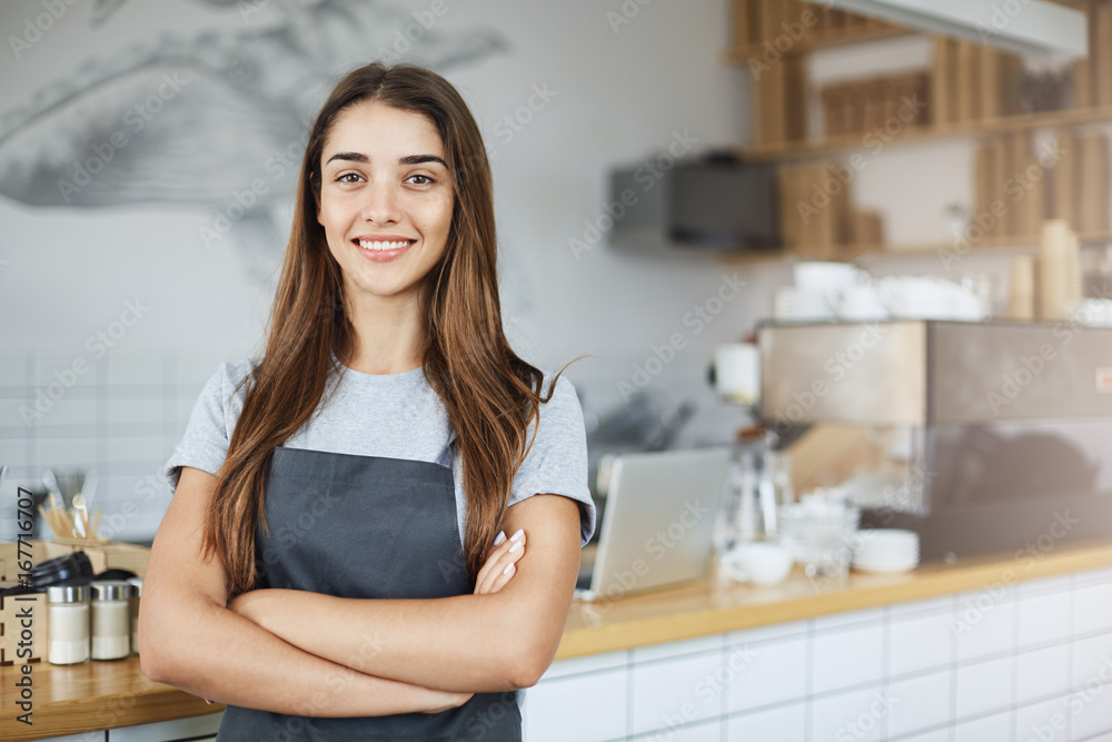 Pastry and coffee shop owner looking confident smiling at camera with arms crossed. Positive business concept. Pastry and coffee shop owner looking confident smiling at camera with arms crossed. Positive business concept.