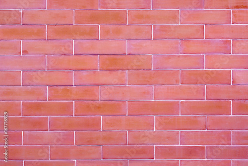 Reddish brown brick wall rough blocks, texture and background.
