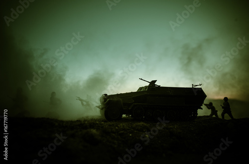 War Concept. Military silhouettes fighting scene on war fog sky background, World War Soldiers Silhouettes Below Cloudy Skyline At sunset. Attack scene. German tank in action