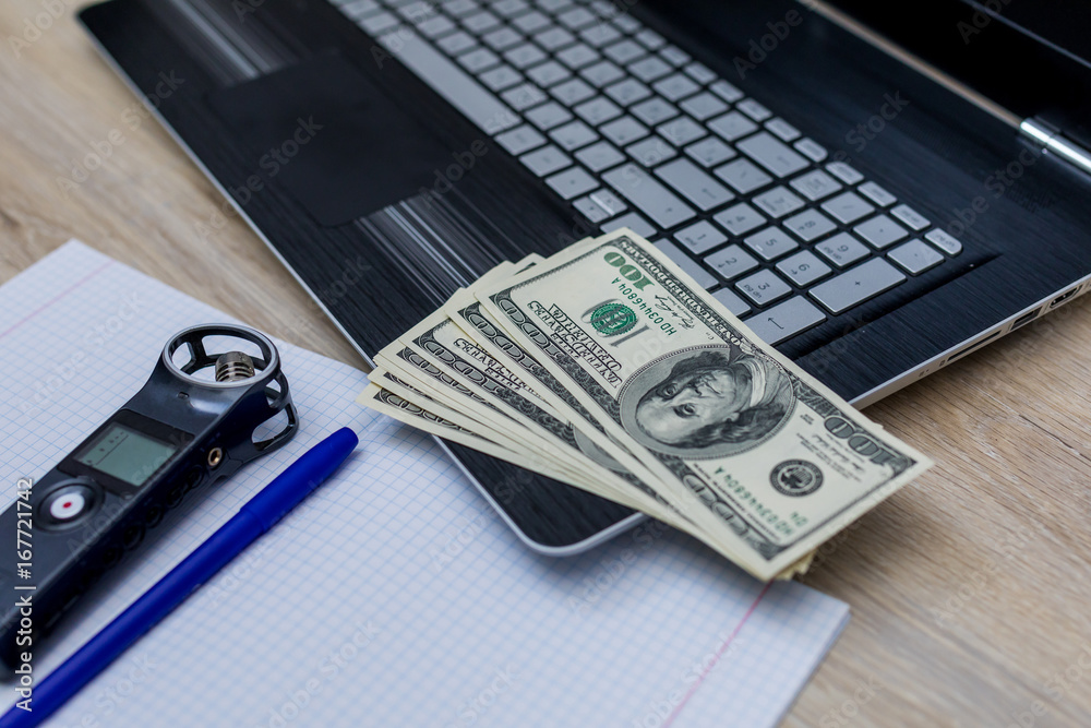 journalist's work at a computer with a voice recorder. Earnings on journalism. Cash journalist's work at a computer with a voice recorder. Earnings on journalism. Cash