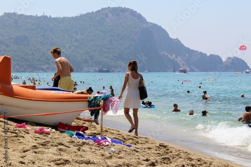 Fototapeta Naklejka Na Ścianę i Meble -  July, 2017 - Vacationers bathe in the sea and sunbathe in the sun on Cleopatra Beach (Alanya, Turkey).