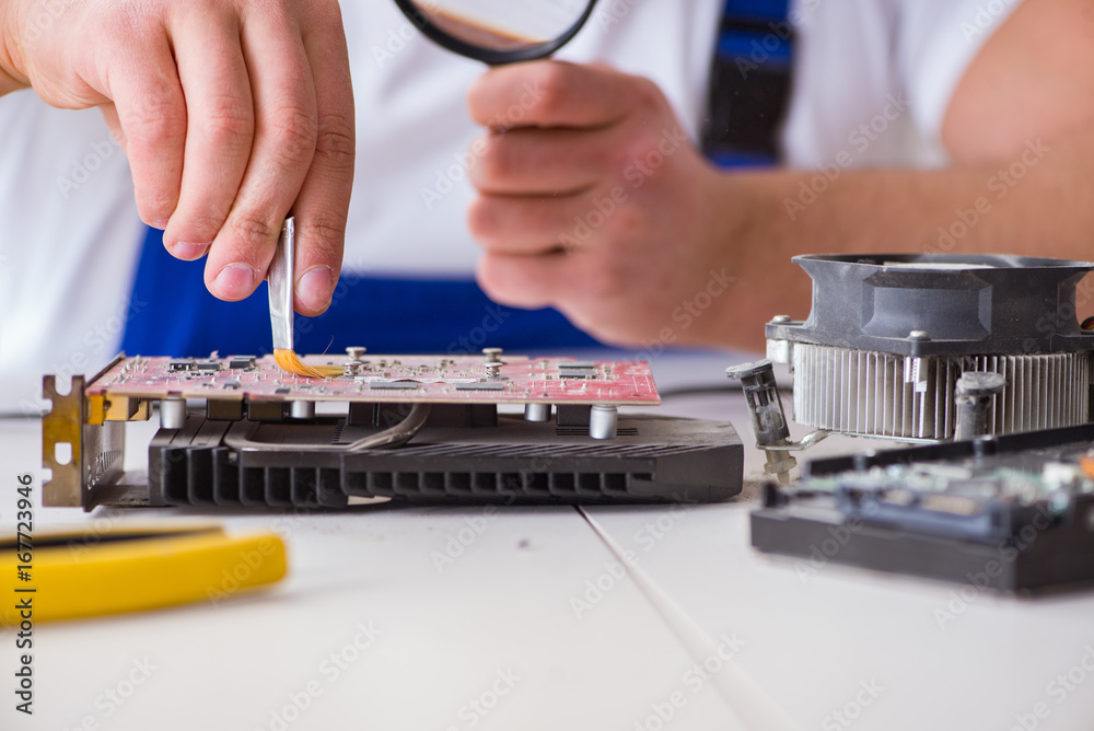 Computer repairman repairing desktop computer Computer repairman repairing desktop computer