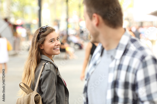 Strangers girl and guy flirting on the street photo