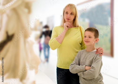 Mother and son looking at classical statues