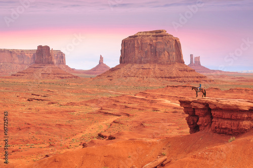 Man on a horse, view from John Ford's Point in Monument Valley with the West Mitten Butte and the Merrick Butte in Utah-Arizona border, United States of America.