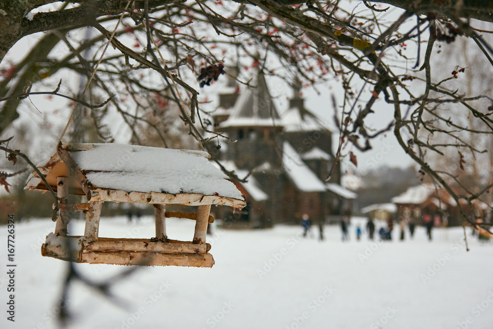 Birdhouse with old wooden Church at background Birdhouse with old wooden Church at background